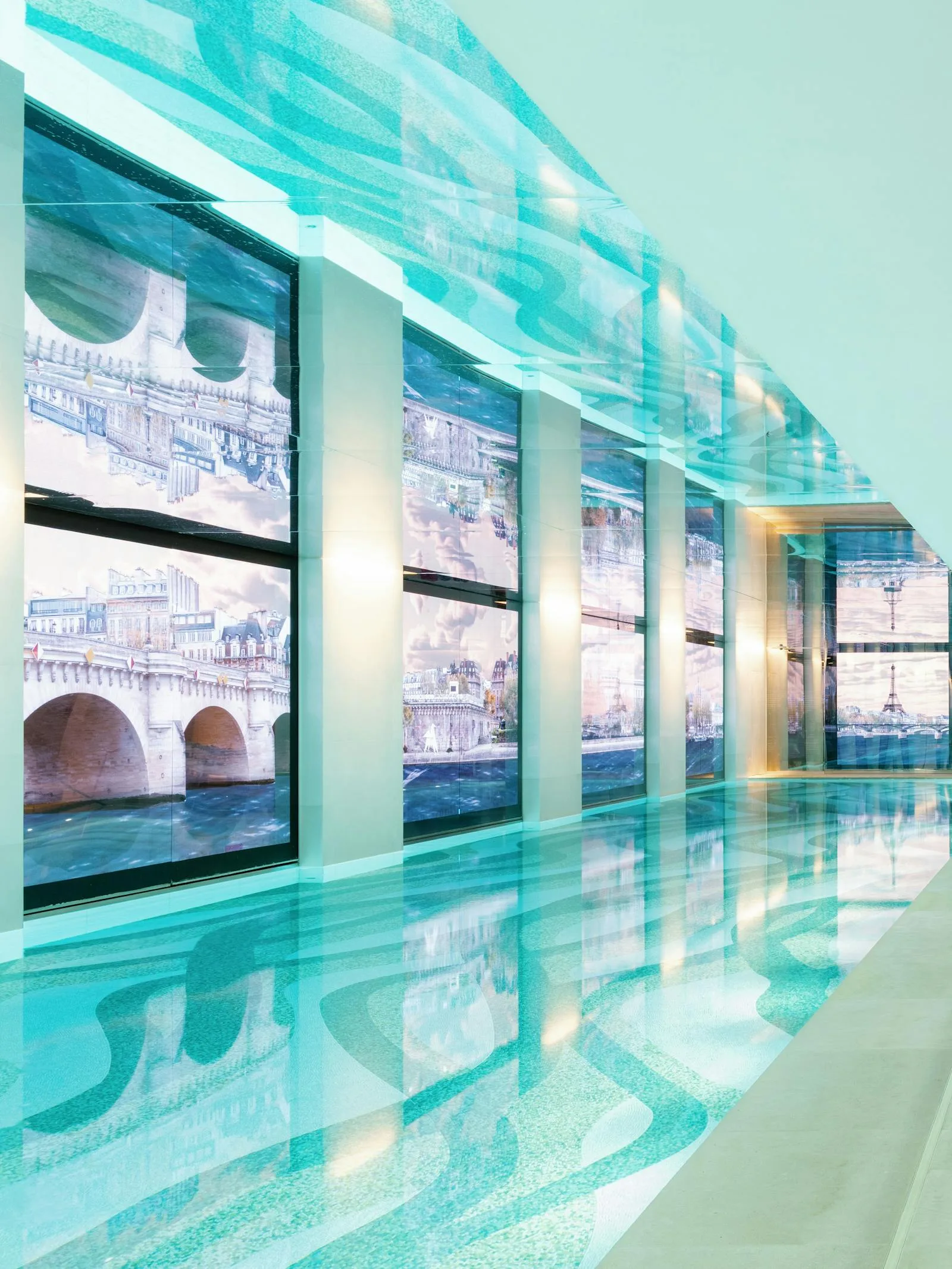 The 30-metre infinity pool at Dior Spa Cheval Blanc, its walls lined with shifting digital views of Paris.