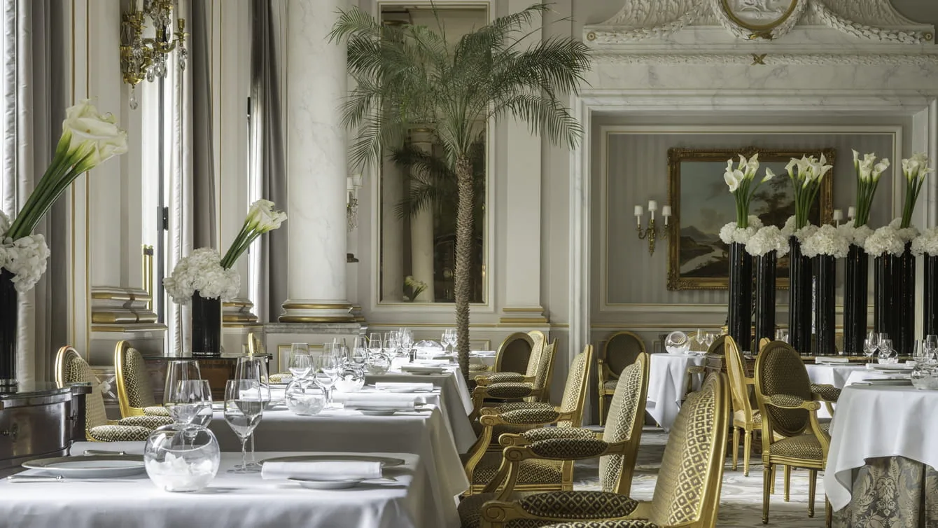 The dining room of Le Cinq, the three-Michelin-starred restaurant at Four Seasons Hotel George V, its signature floral displays throughout.