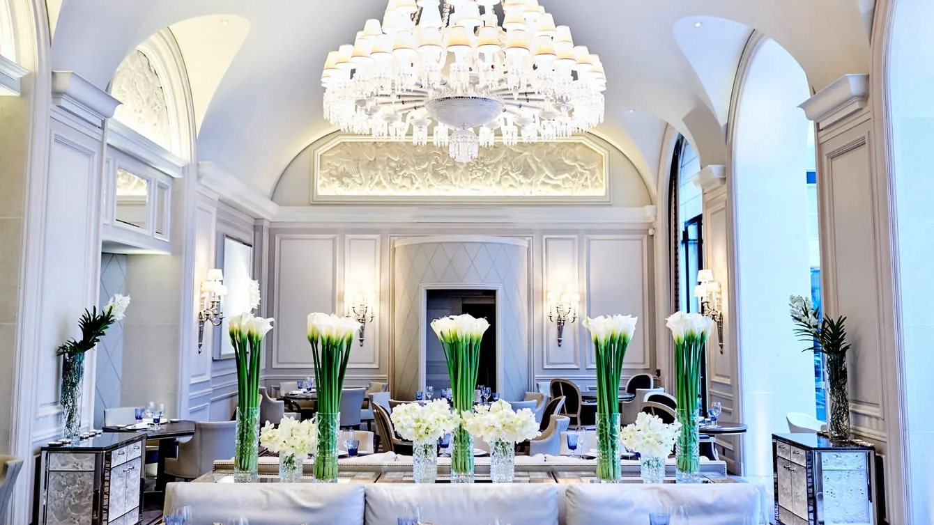 Le George, the Mediterranean restaurant helmed by chef Simone Zanoni, its dining room dressed with the tall floral displays this hotel is known for.