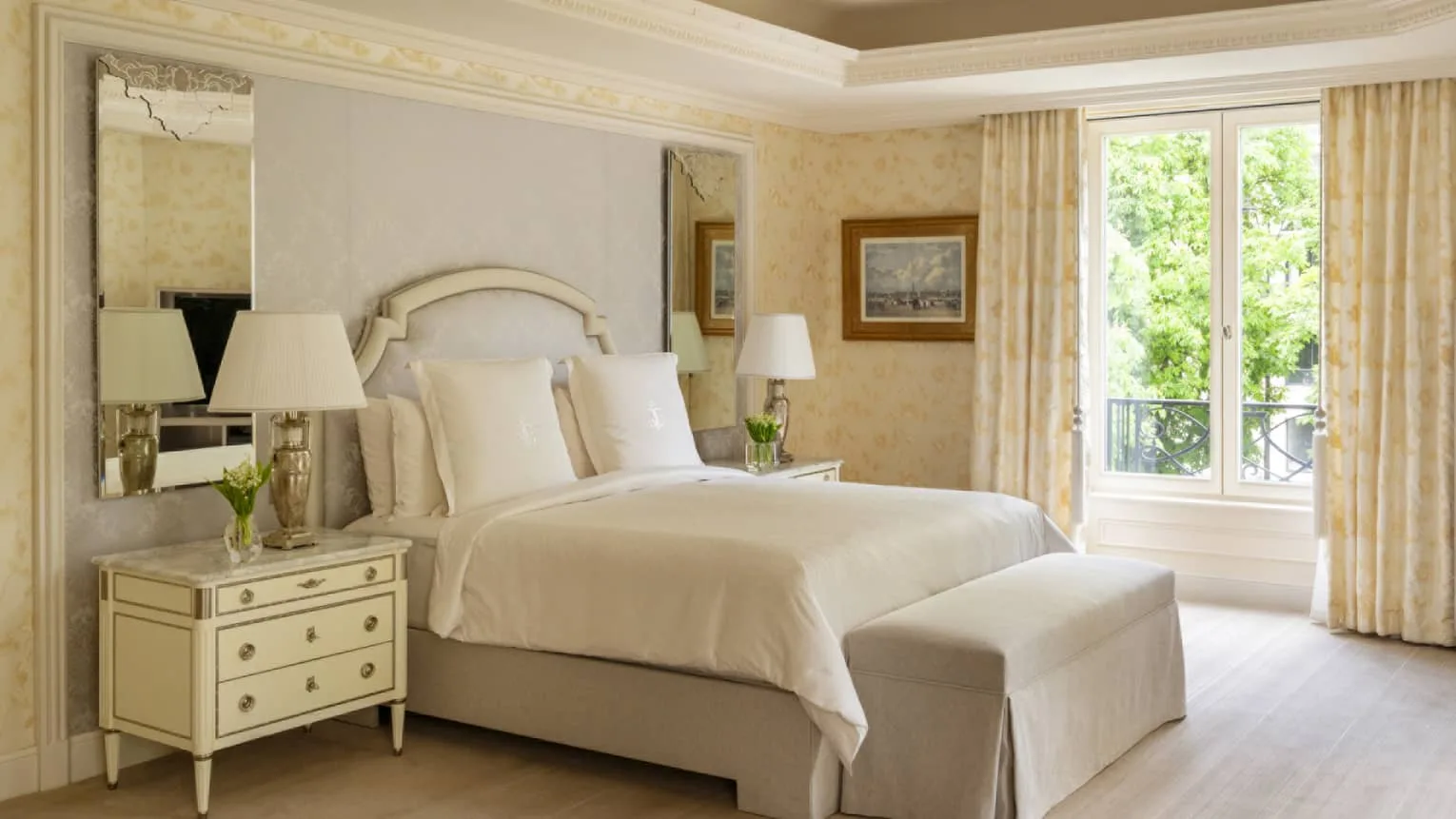 The bedroom of the Royal Suite at Four Seasons Hotel George V, Paris, with a private balcony.