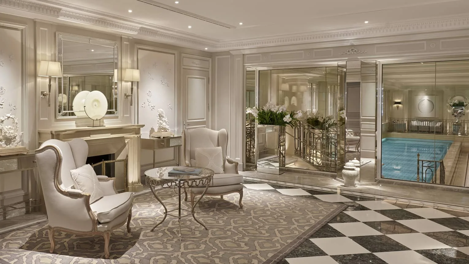 The spa lounge at Four Seasons Hotel George V, Paris, its pool visible through mirrored glass.