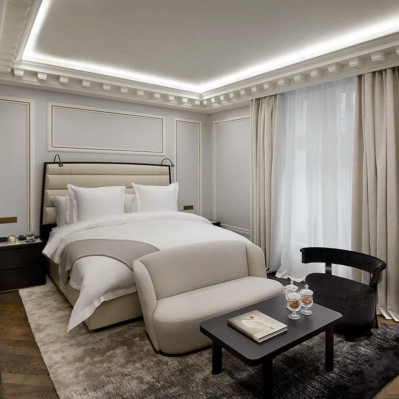 A Premier Room in soft greige tones, with panelled walls and a reading chair by the window.