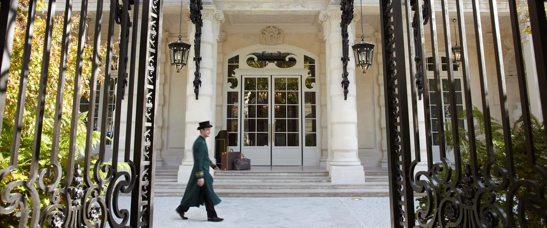A doorman crosses the wrought-iron gated courtyard of Shangri-La Paris, the former hôtel particulier of Prince Roland Bonaparte.