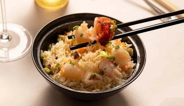 A signature dish at Shang Palace, lobster and scallop fried rice presented tableside.