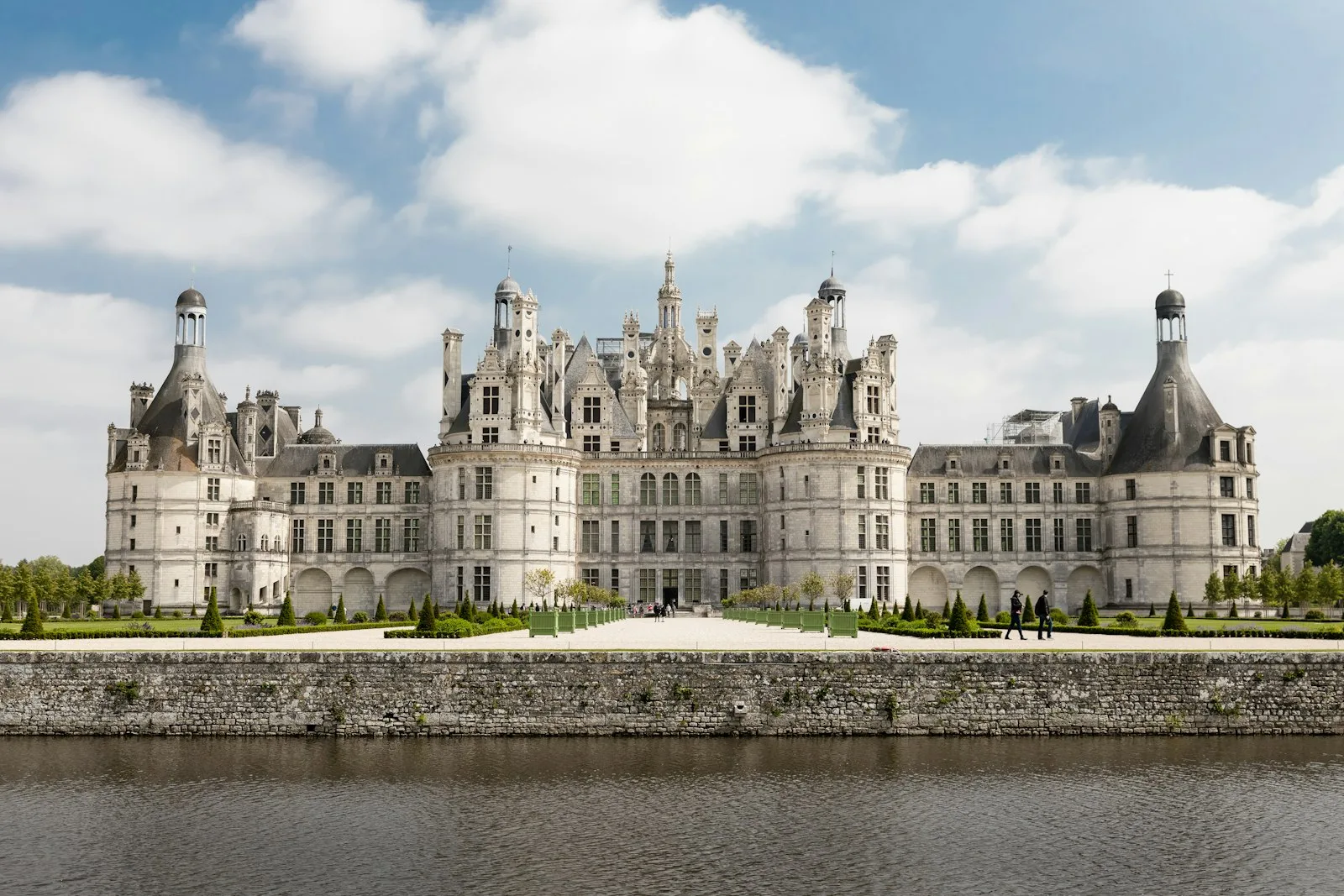 Château de Chambord's turreted facade reflected in its moat.
