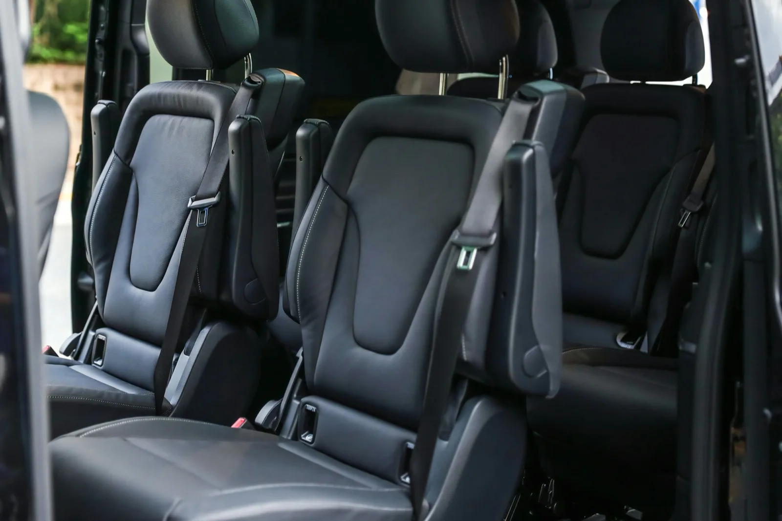 Rear bench seating in a wide-body luxury van, standard configuration.
