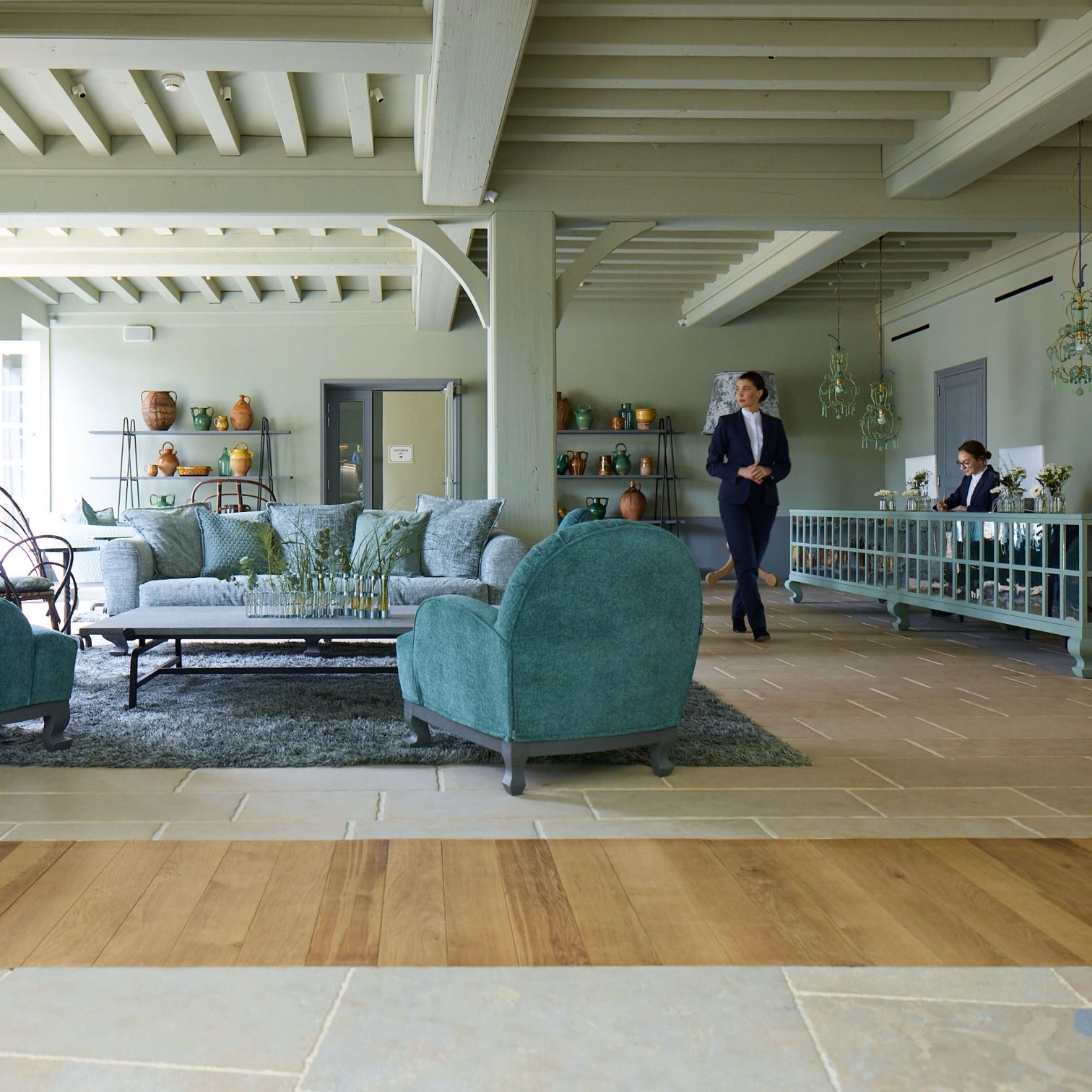 The reception hall, with sage-green woodwork and antique Burgundian pottery on display.