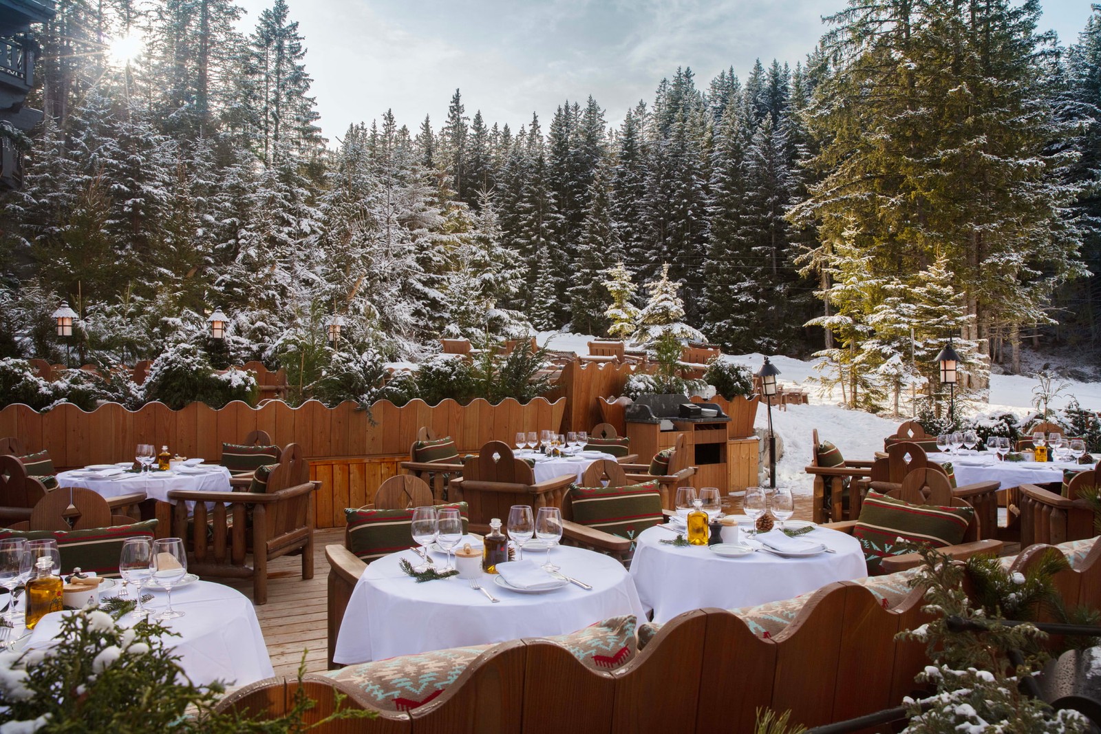 Fouquet’s Courchevel’s Loulou restaurant terrace, tables set among snow-covered pines