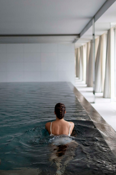 The spa's indoor pool, minimalist in design with floor-to-ceiling glass.