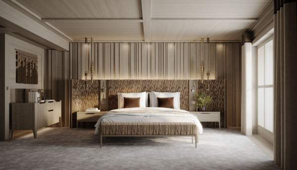 A redesigned room at Le K2 Palace, with dark wood panelling and warm lighting.