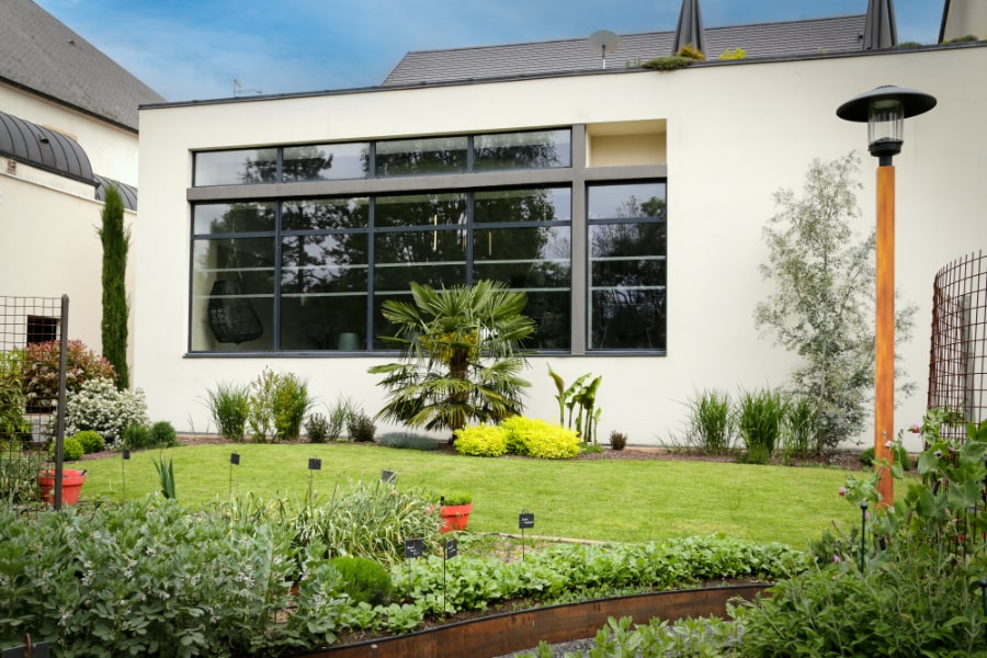 The hotel's contemporary garden wing, with the village rooftops of Vosne-Romanée behind.
