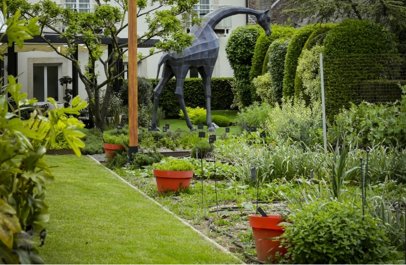 The hotel's kitchen garden, with a geometric giraffe sculpture among the herb beds.