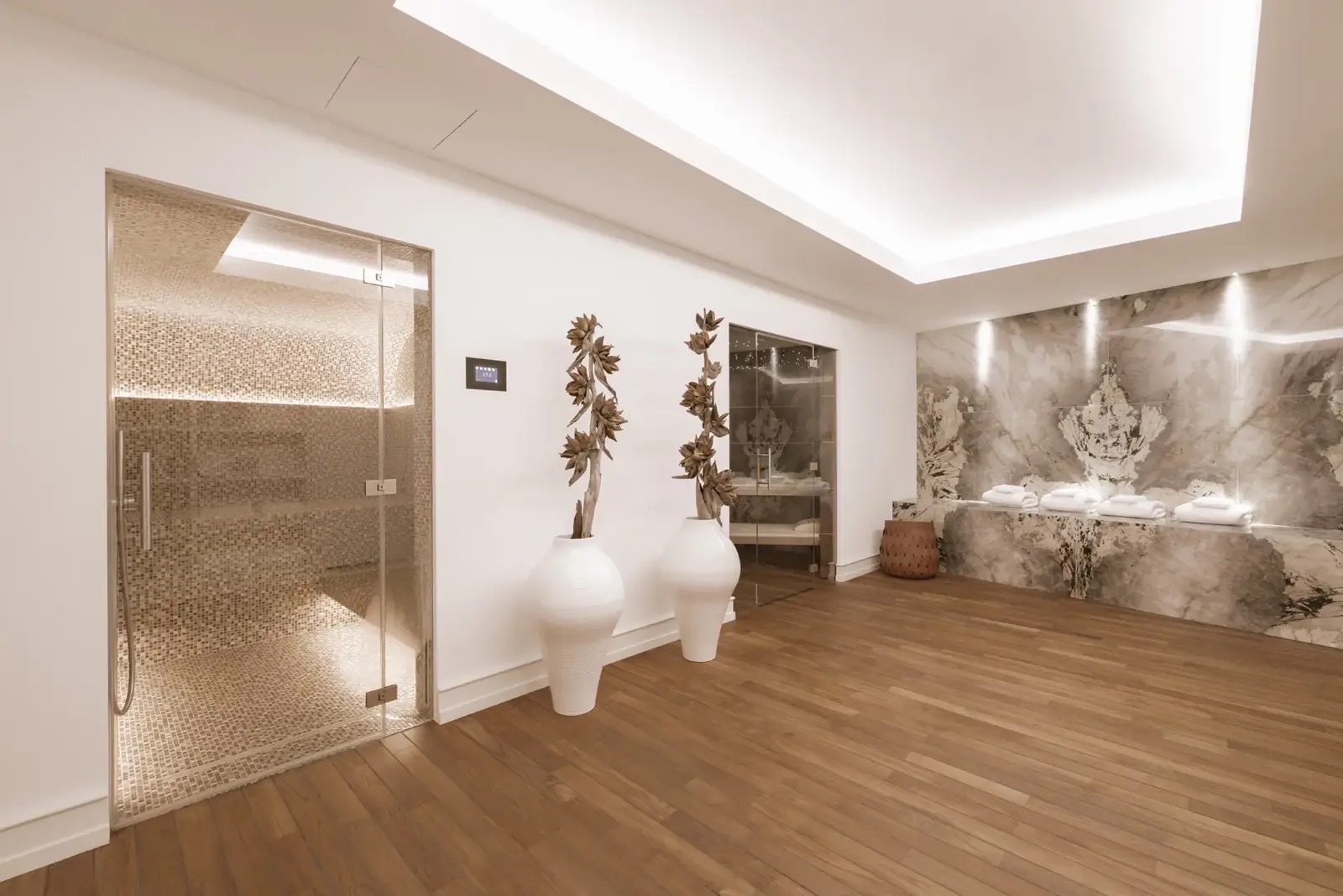 L'espace détente du spa résidentiel, avec son hammam et son coin repos habillé de marbre.