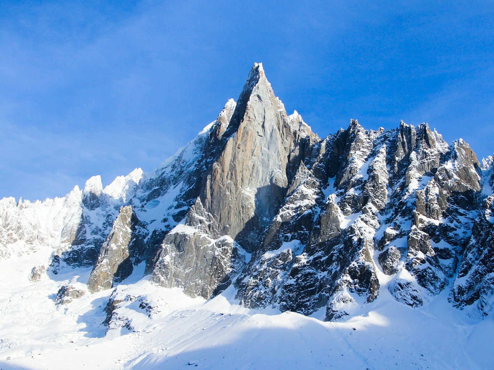 Jagged, snow-covered granite spires of the Mont Blanc massif above Chamonix.